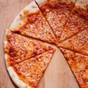 photo of a NY style pizza with slice missing
