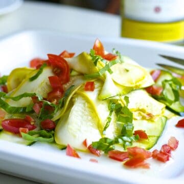 Colorful zucchini salad with ribboned zucchini, red pepper, herbs and more.