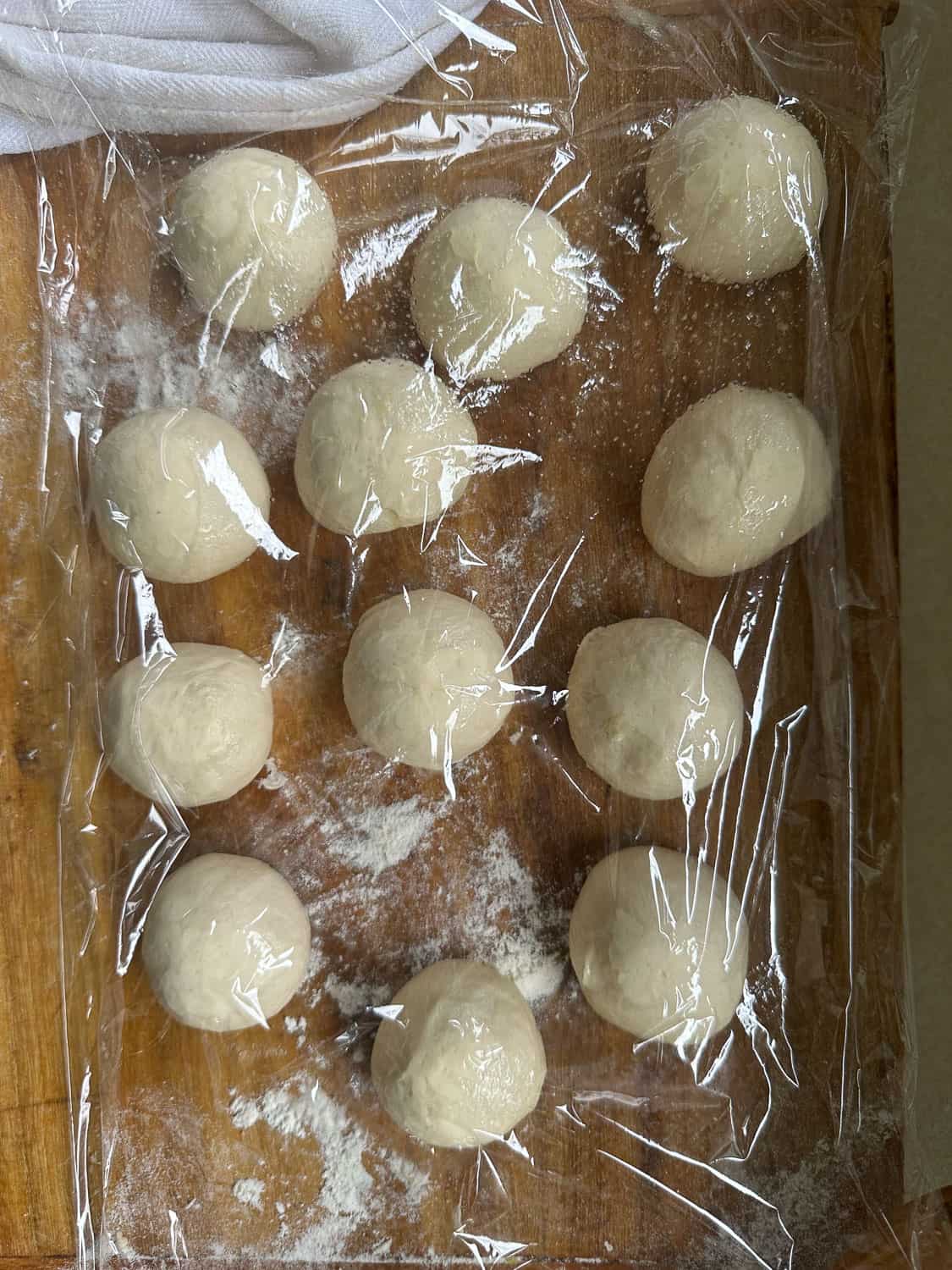 dough balls under plastic wrap 