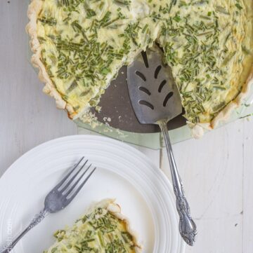 top view of deep dish asparagus quiche with pie server