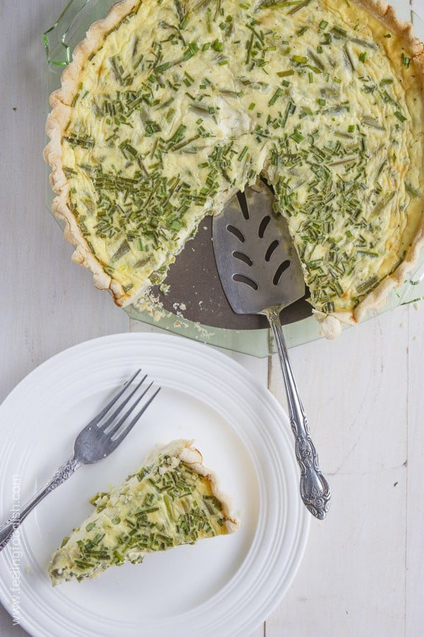 top view of deep dish asparagus quiche with pie server