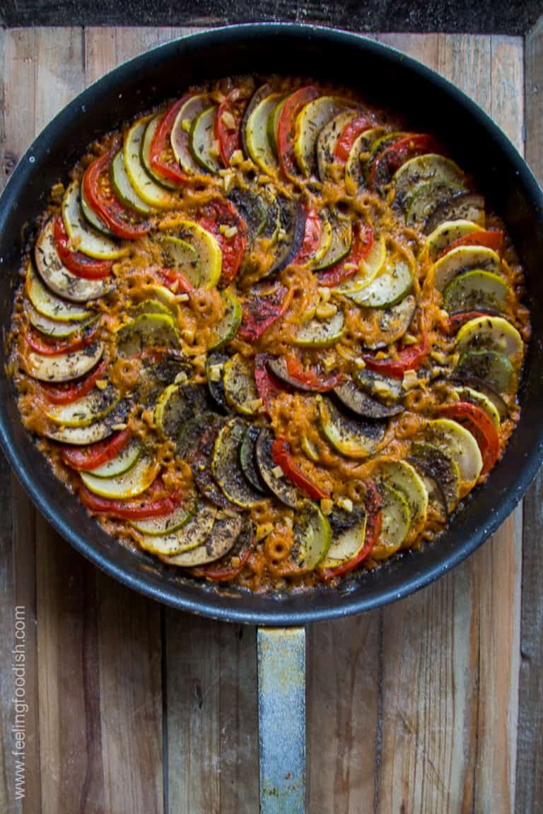 top view of slow roasted ratatouille in black pan on wooden board