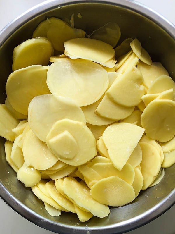 a bowl of sliced potatoes ready for the pizza!