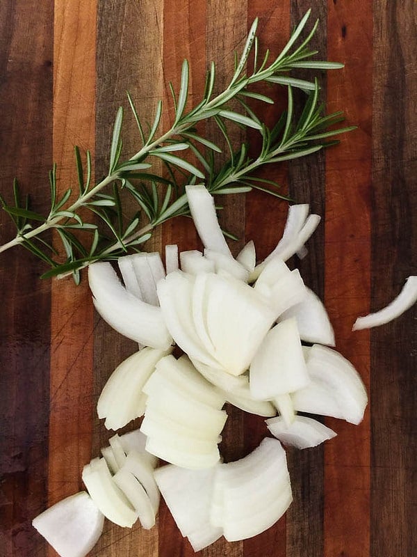 sliced onions and springs of rosemeary