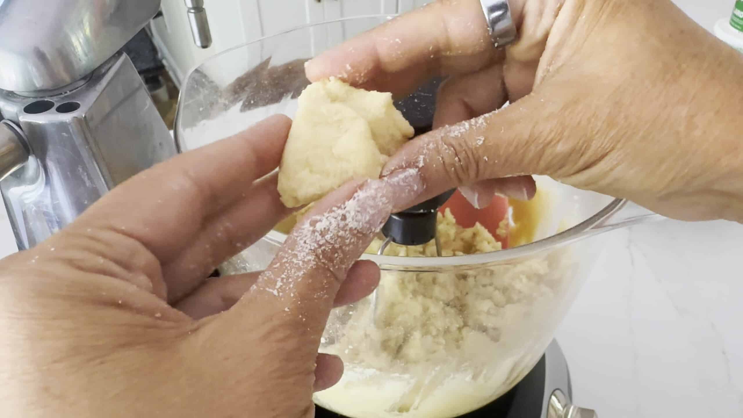 Dough consistency of pignoli cookies in hands. 