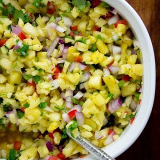 This healthy pineapple salsa is perfect for snacking on with chips or is delish as a topping for grilled fish!