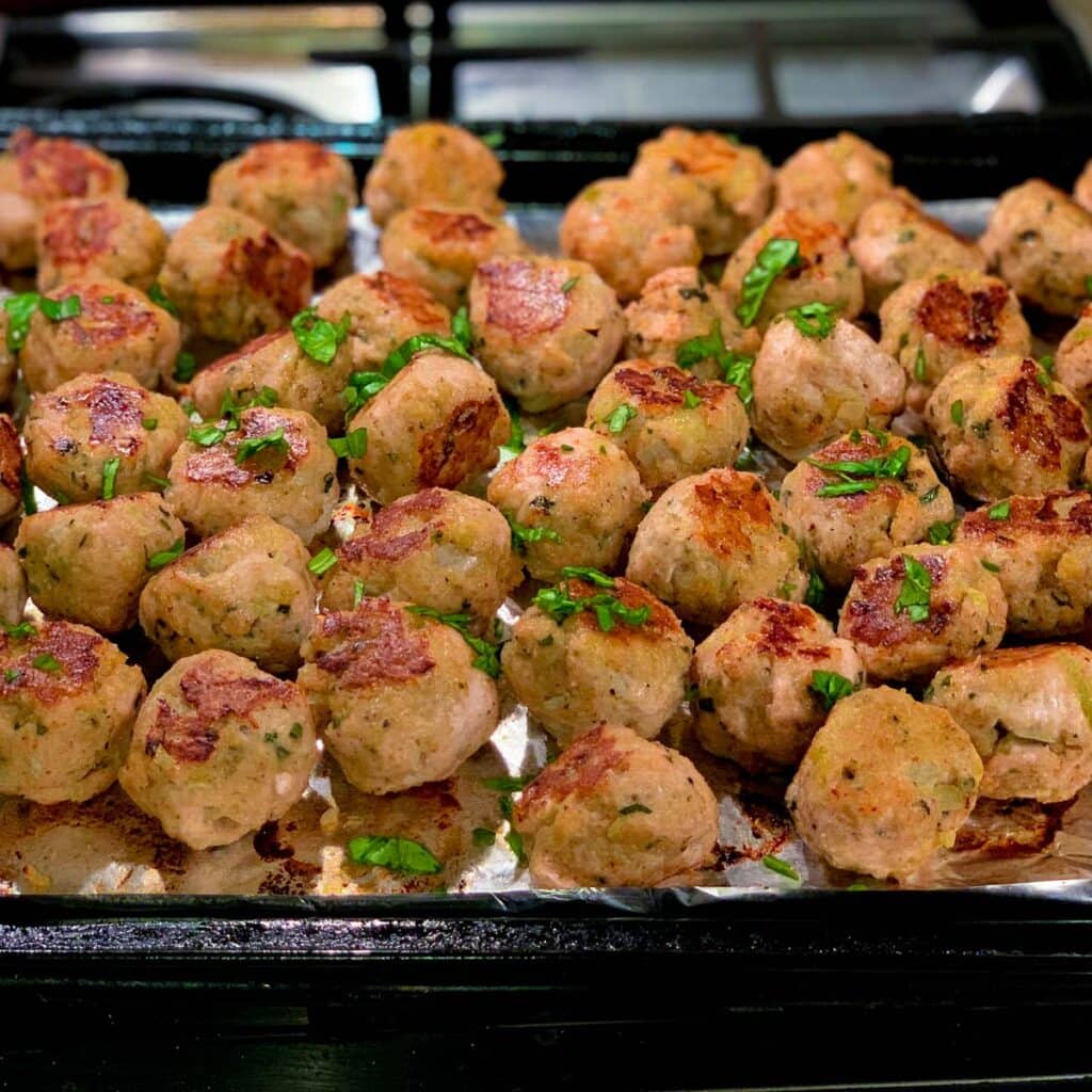 baked turkey meatballs on tray on stovetop