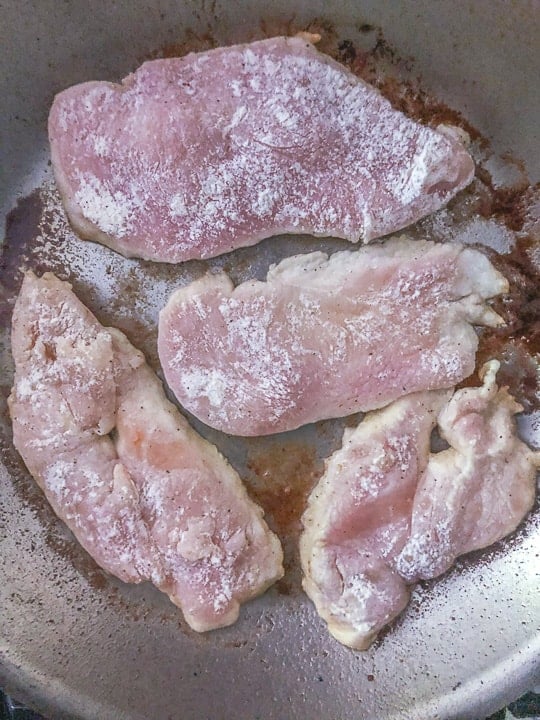 pan of sliced chicken cooking on stovetop