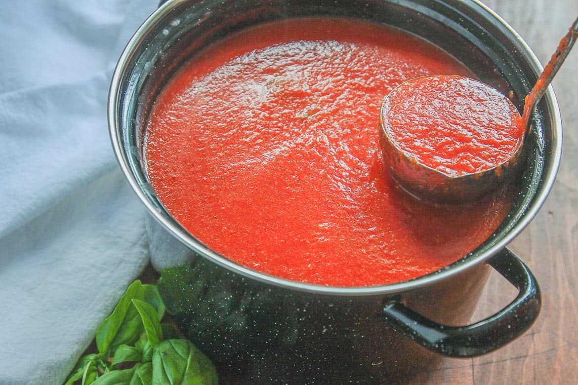 pot of homemade spaghetti sauce with fresh basil