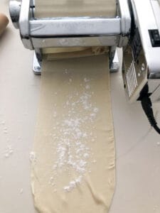 Dough passing through the pasta machine.
