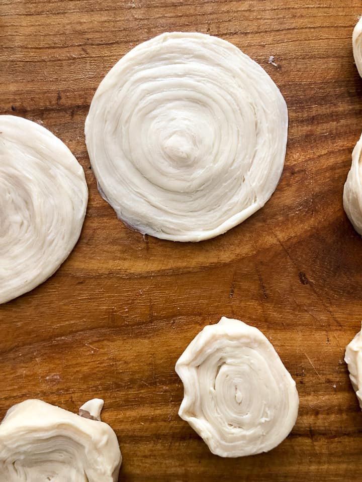 Multiple slices of the rolled dough cylinder. 