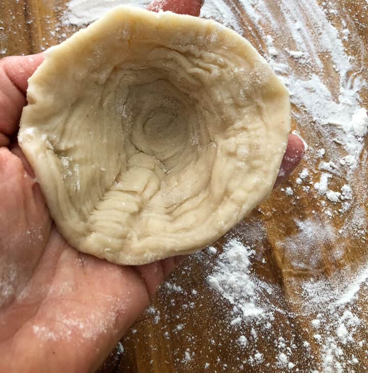 Forming the dough slices into a cone shape. 