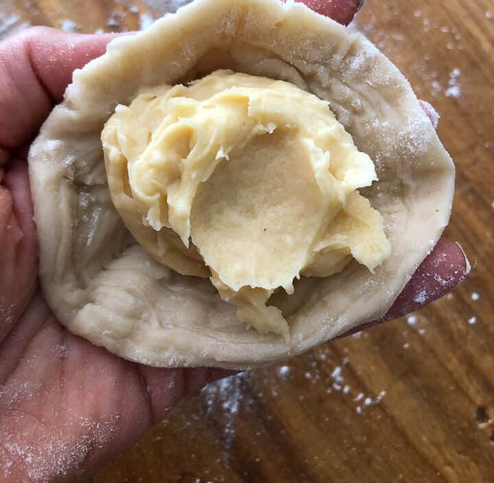 Filling the cone shapes with pate a choux. 