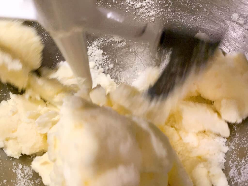 close up of butter and sugar creamed in a standing mixer