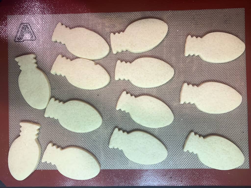 baked sugar cookies on half sheet tray lined with silicone baking mat