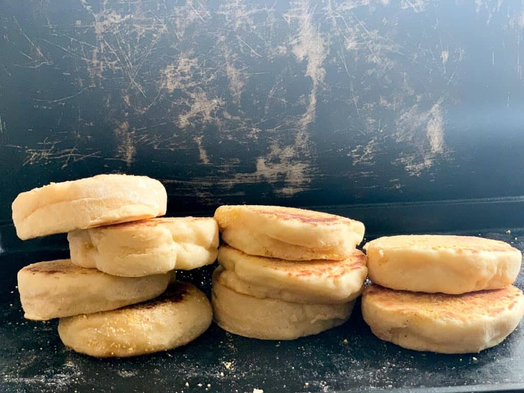 Side view of homemade English muffins stacked on top of each other 