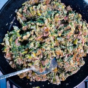 overhead view of utica greens in black pan with serving spoon