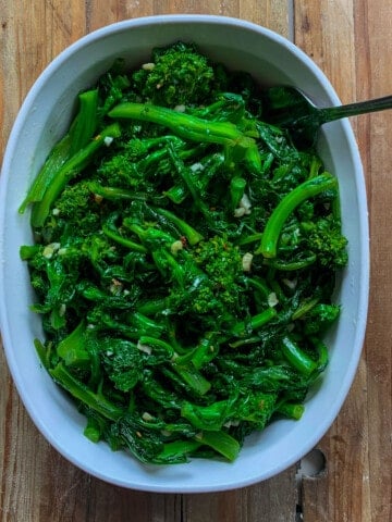 Italian broccoli rabe in white dish with spoon