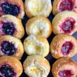 top view of baked kolache with fruit on black tray