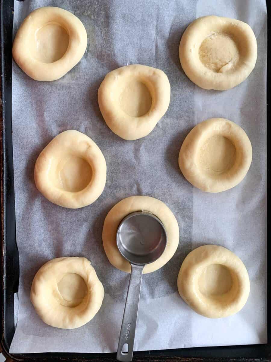 kolache dough with wells in center ready to be filled 