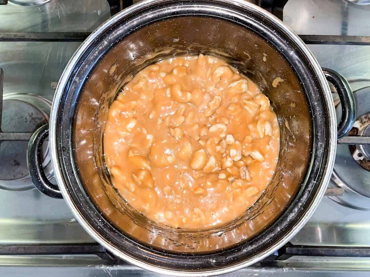 cashew brittle in pot ready to be poured on flat pan