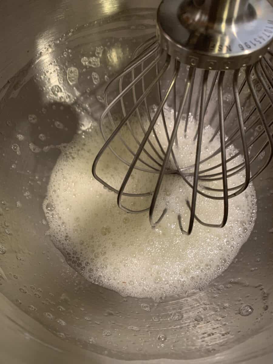 frothy egg whites in mixing bowl