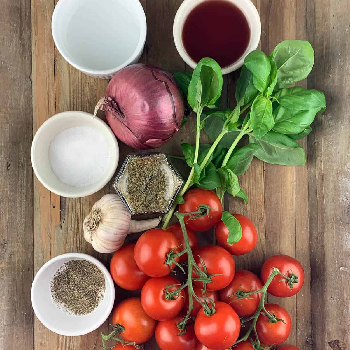 overview of tomato salad ingredients on wooden background