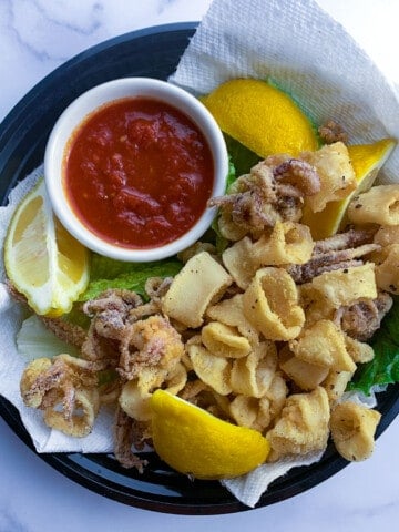 plate of fried calamari rings with red sauce