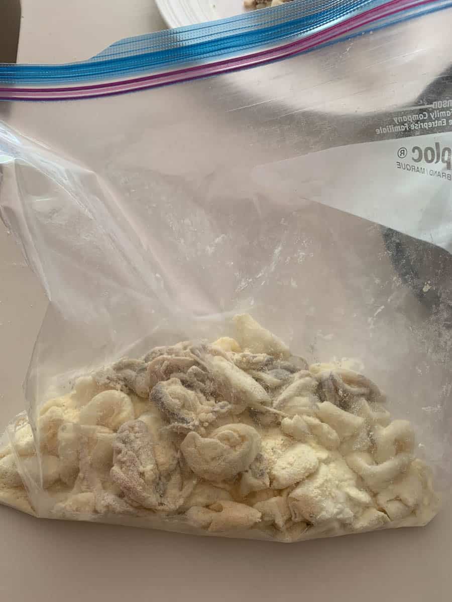 calamari in plastic bag with flour