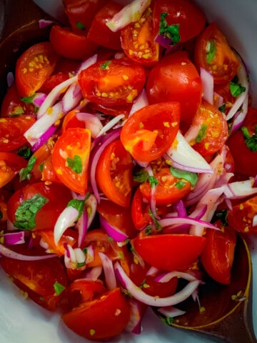 top view of Italian tomato salad in white bowl