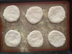 flattened bialys on baking sheet