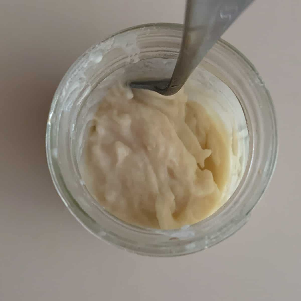 top view of cooked tangzhong in small glass jar with spoon