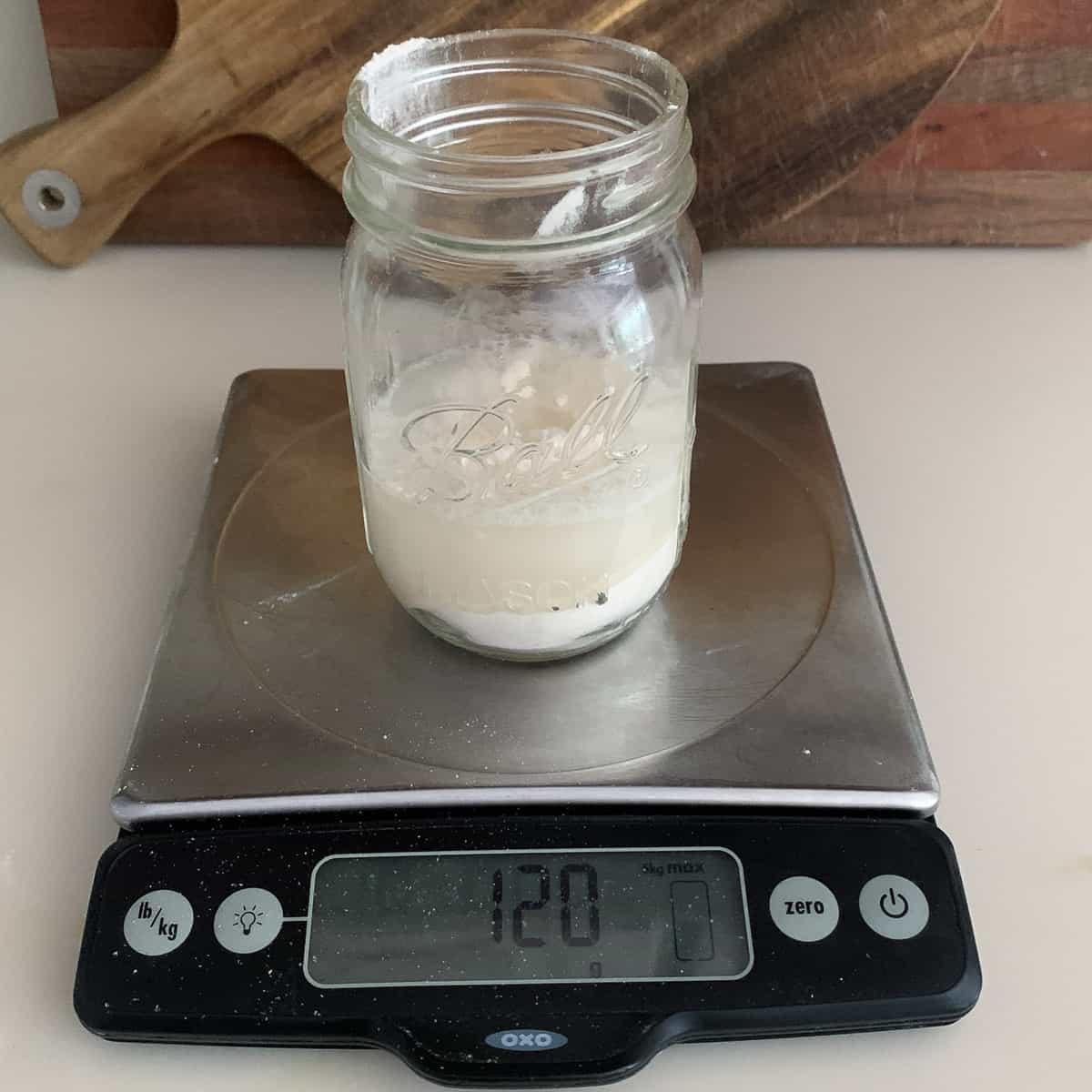 ball jar on scale measuring water at 120 grams
