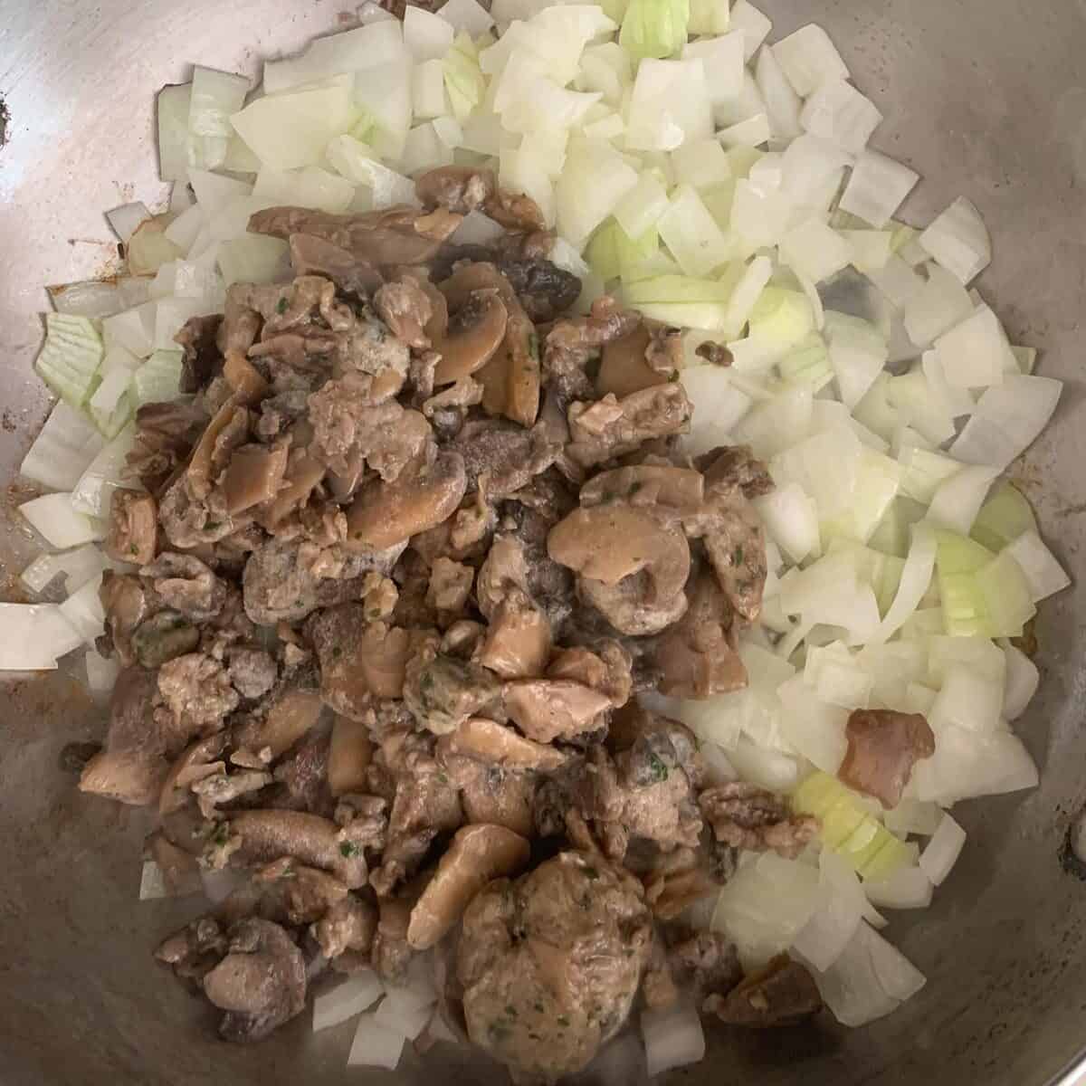 adding mushrooms to pan of cooked onion and garlic