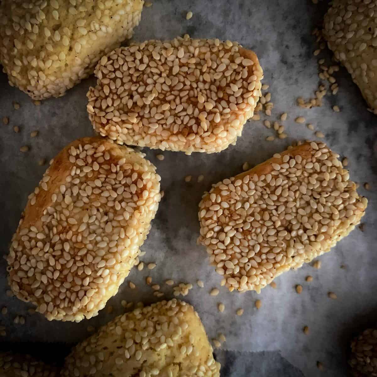 bottom of sesame seed cookies lightly browned on parchment paper