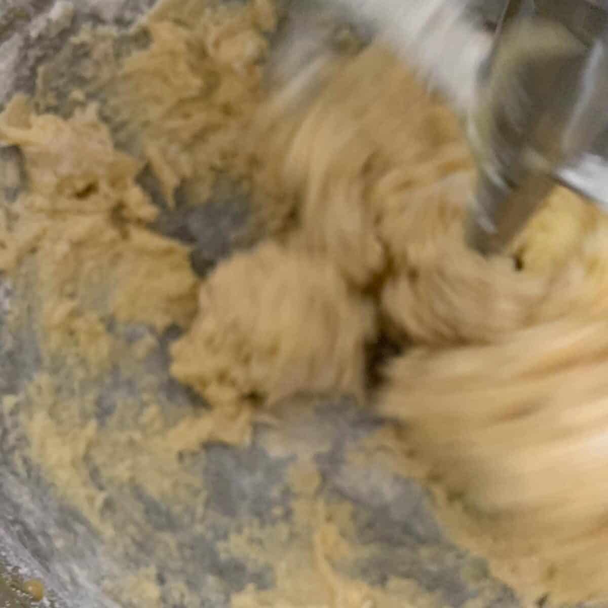 close up of cookie dough mixing in bowl