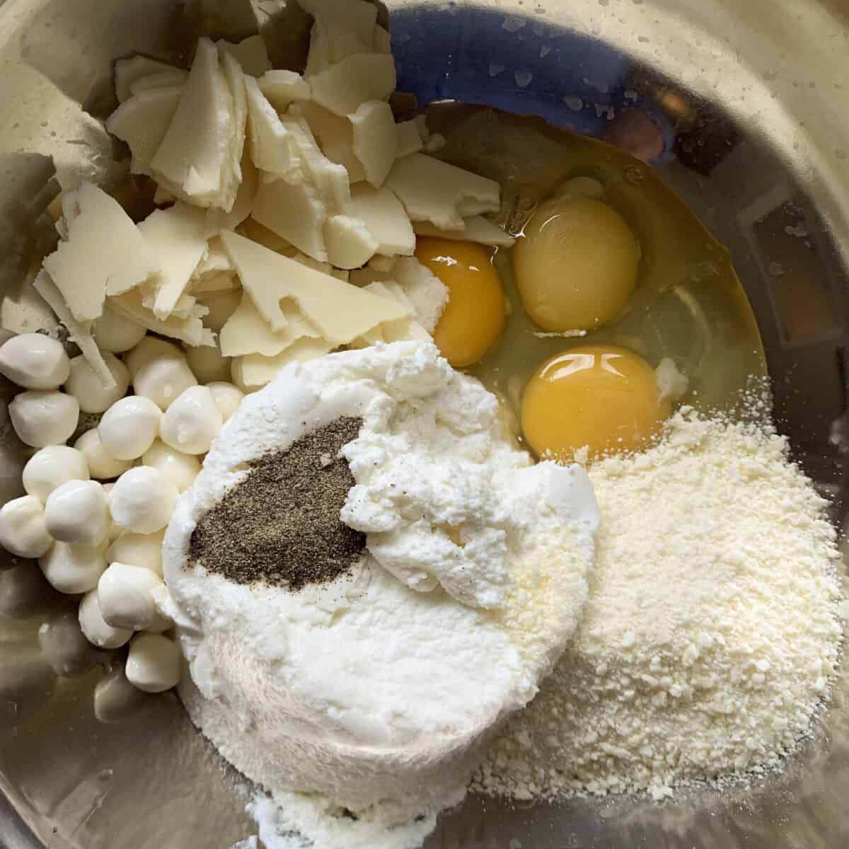 Ingredients for cheese mixture in silver bowl