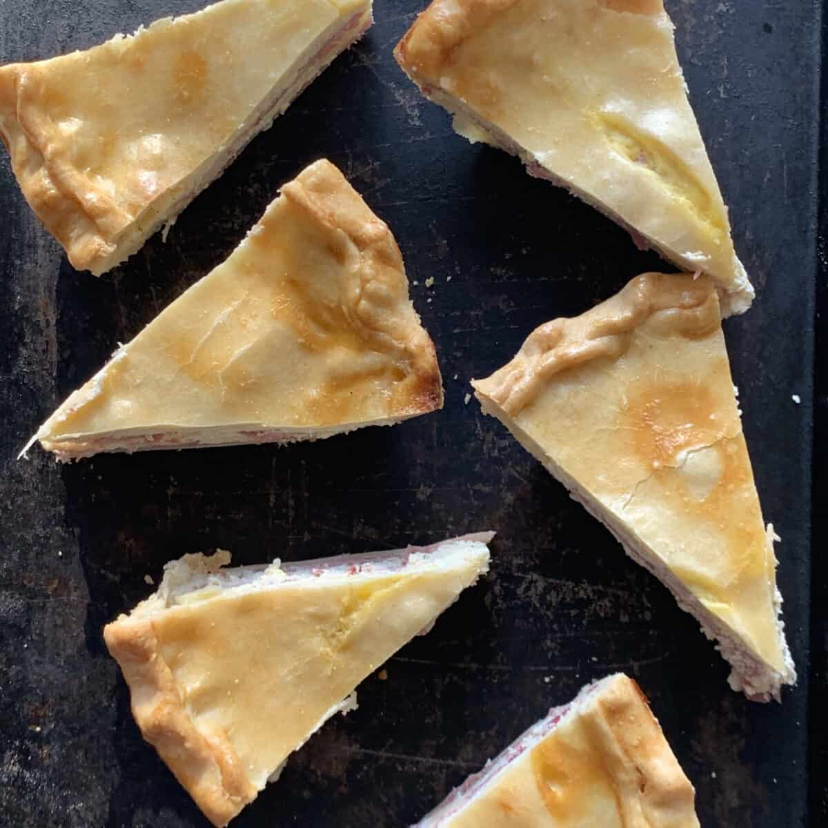 slices of easter pie on black pan