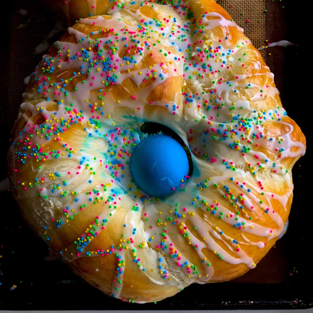 Overhead view of easter bread with blue egg