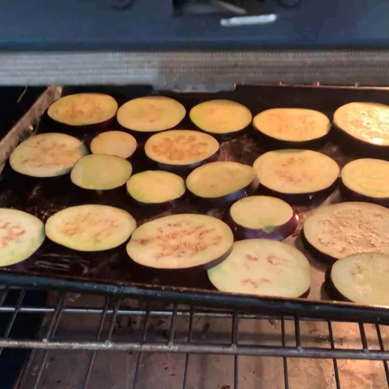 sliced eggplant on baking sheet in oven