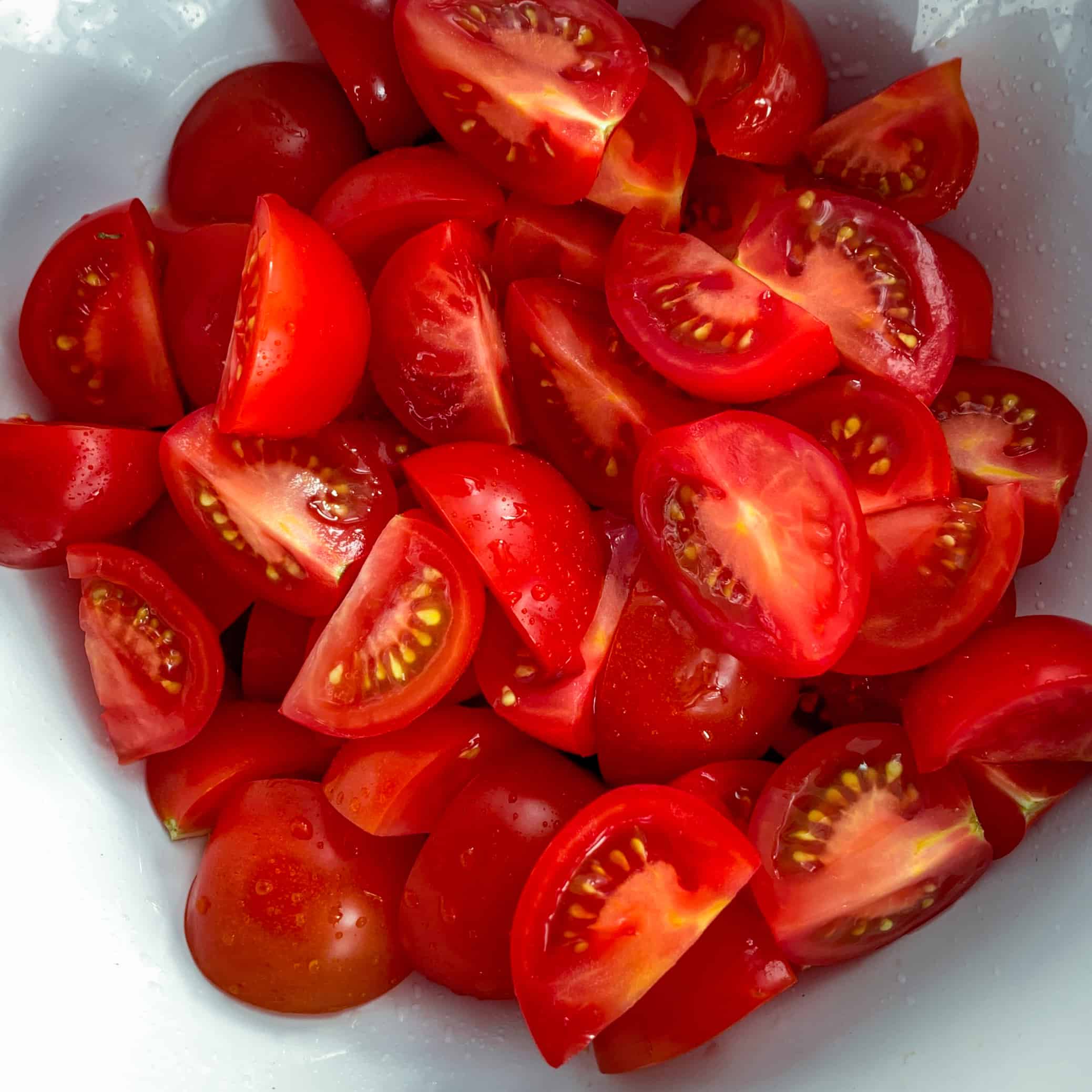 chopped tomatoes in white bowl