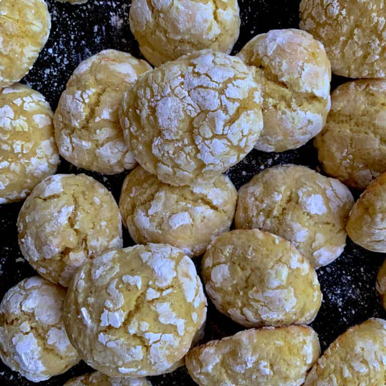 top view of italian orange cookies on black cookie sheet