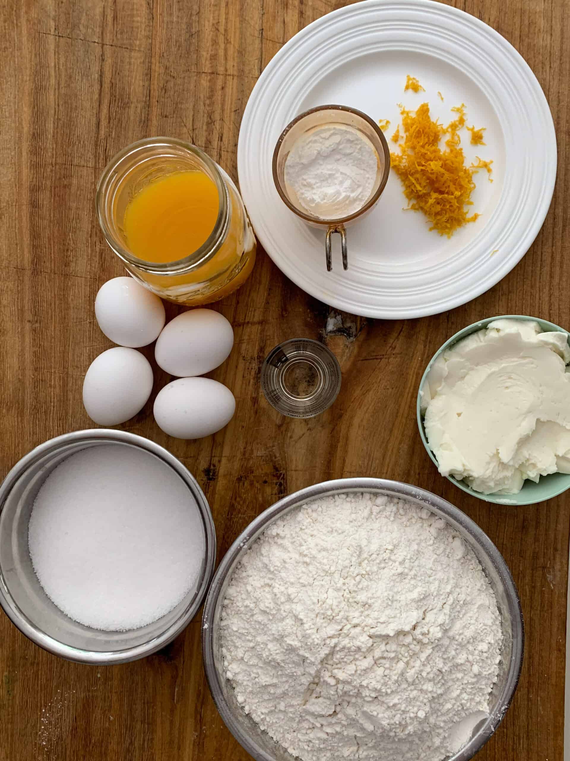 ingredients for Italian orange cookies on wooden board