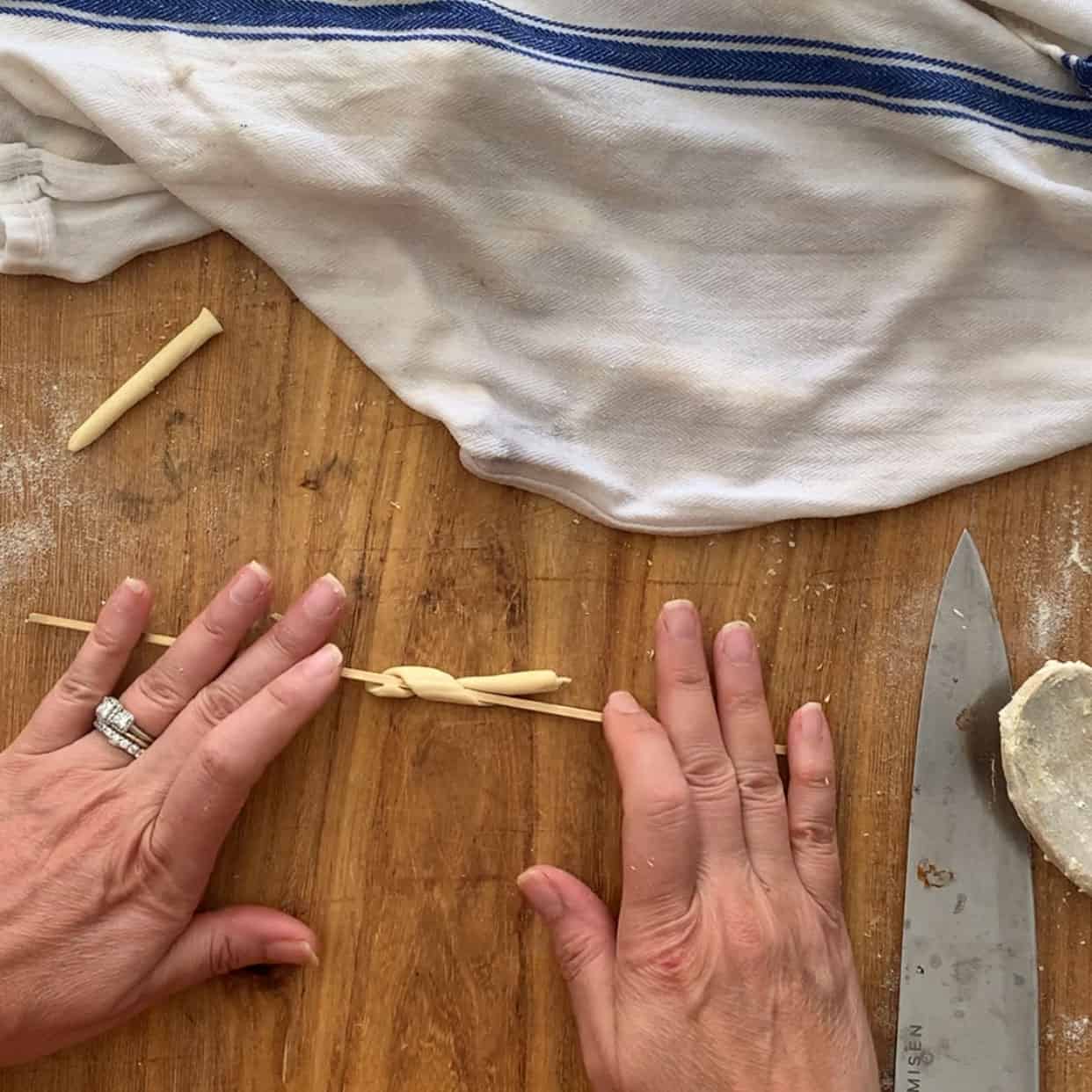 rolling pasta dough into fusilli using a fusilli iron