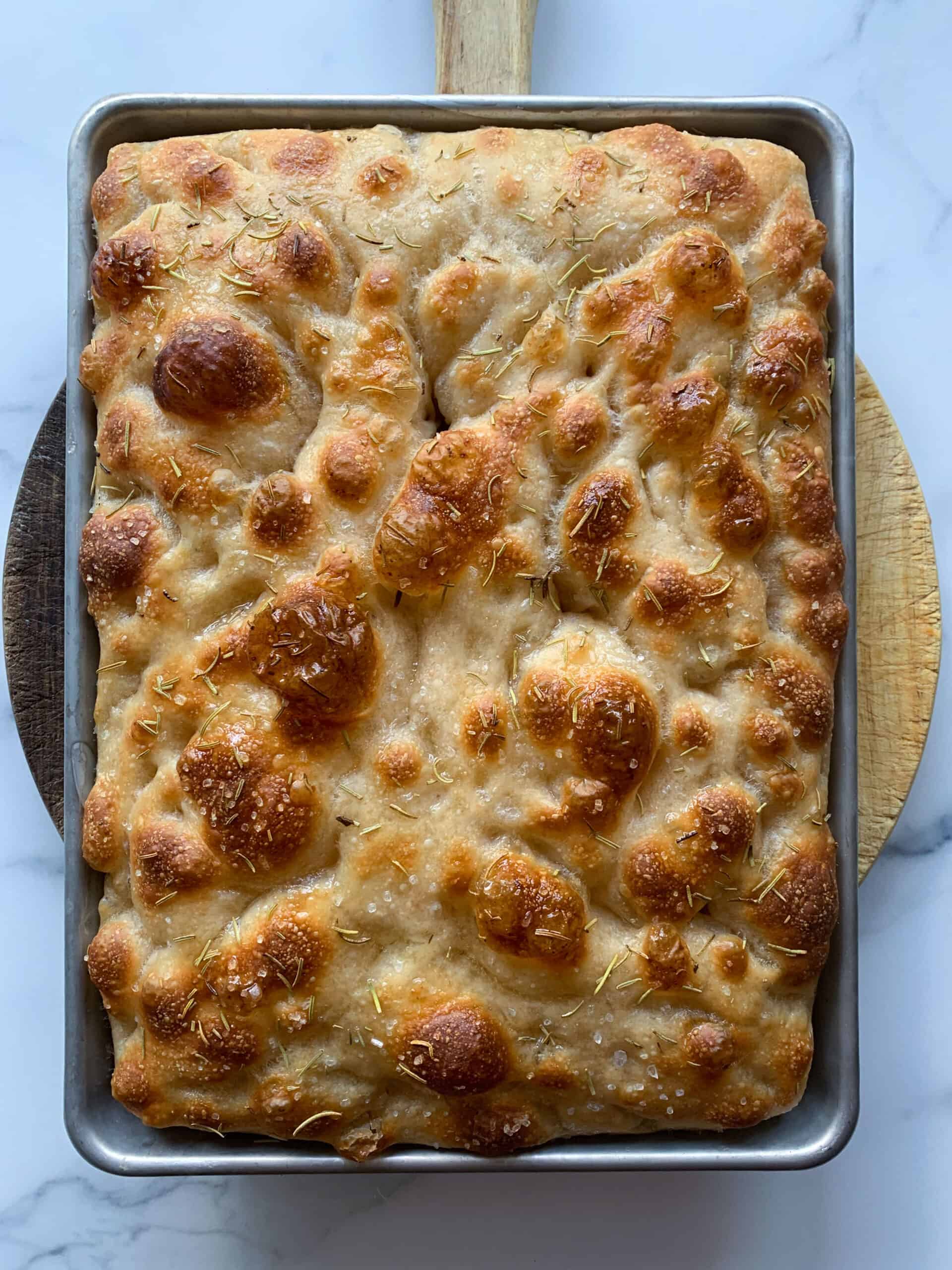just baked sourdough focaccia bread on marble background