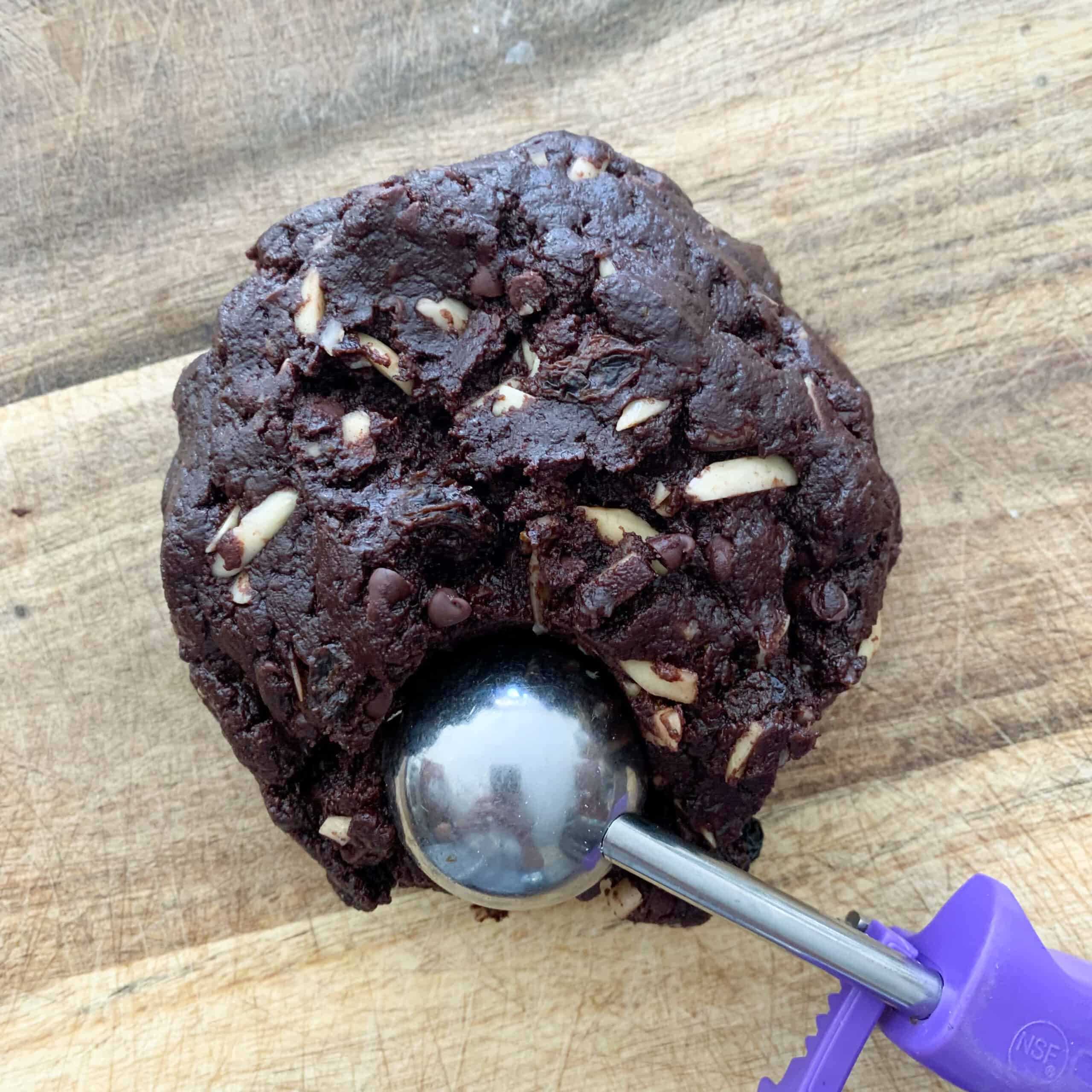 Italian chocolate cookie dough on wooden board with cookie scoop