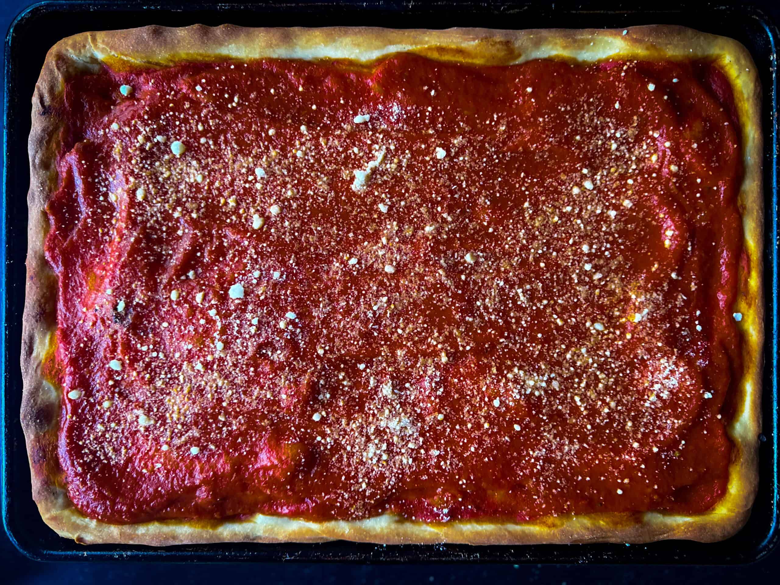 just baked tomato pie sprinkled with grated cheese unsliced