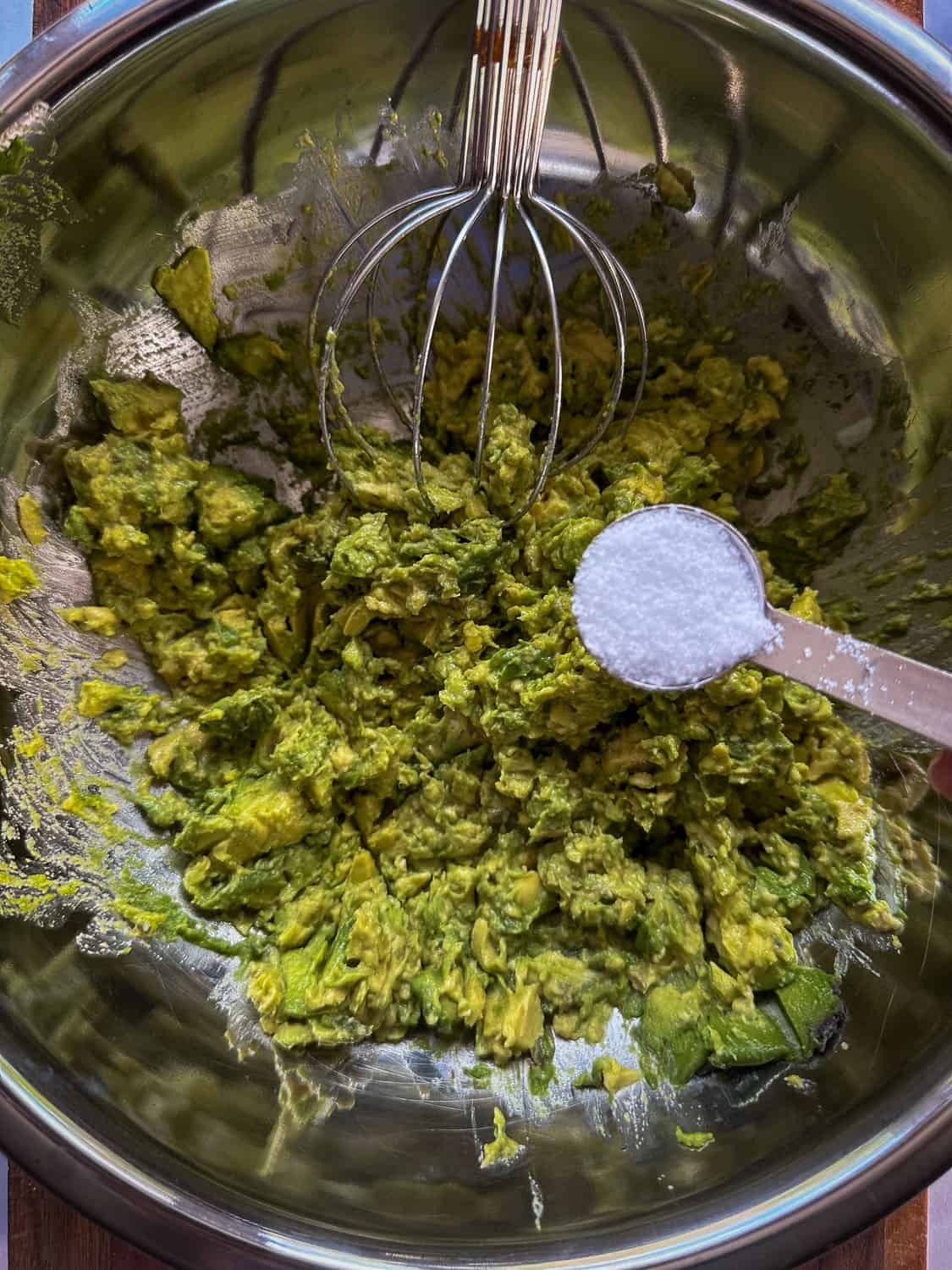 Adding salt to mashed avocado