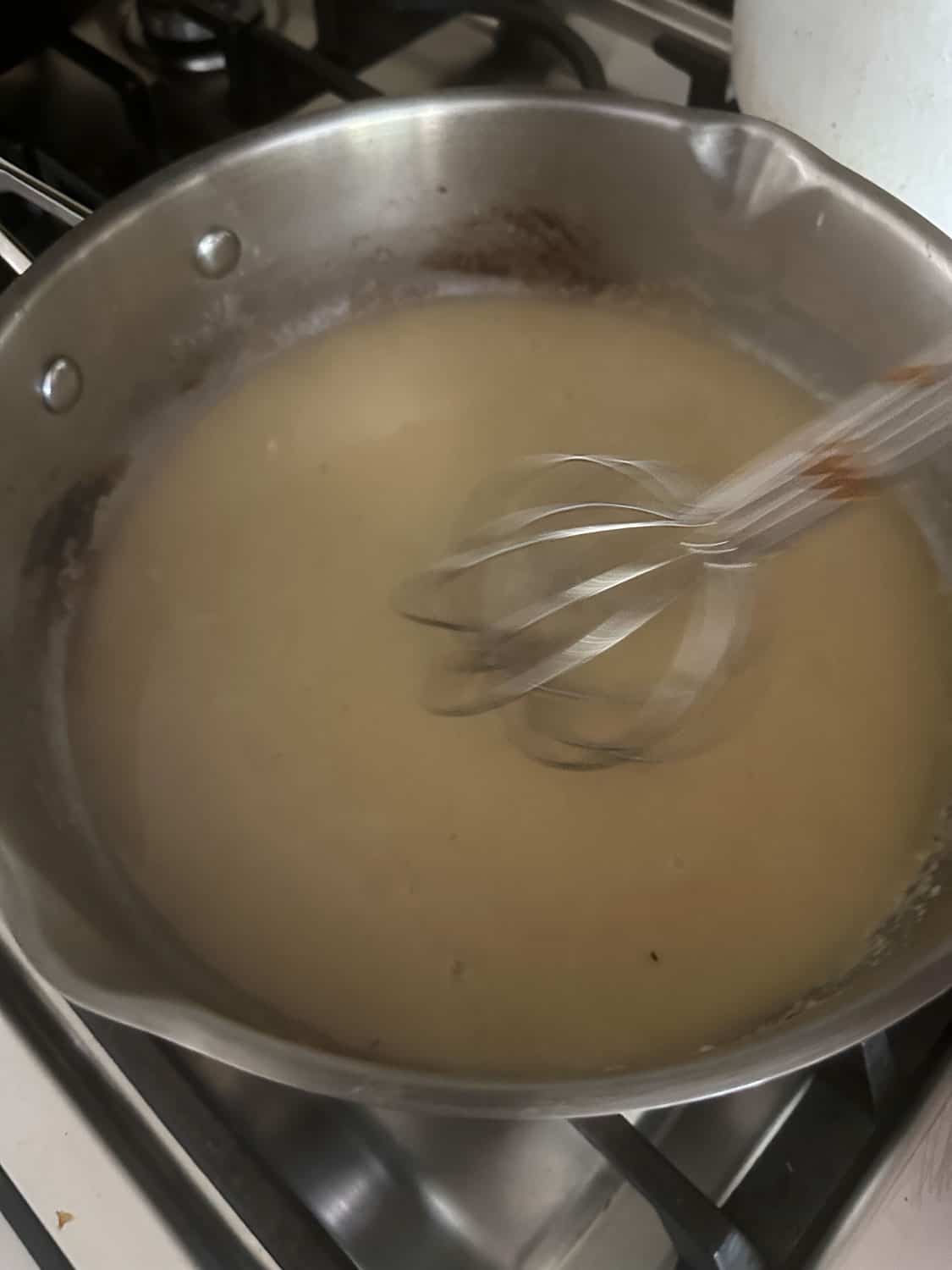 whisking in the broth and cream