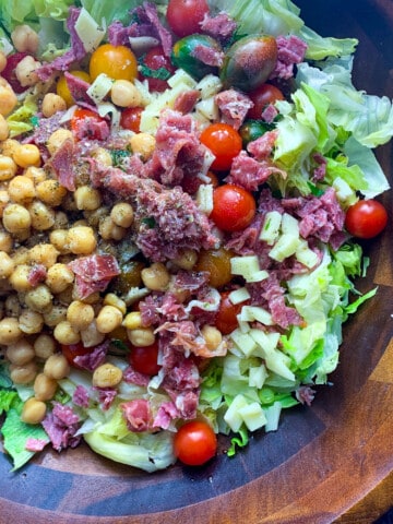 top view of italian chopped salad in wooden bowl